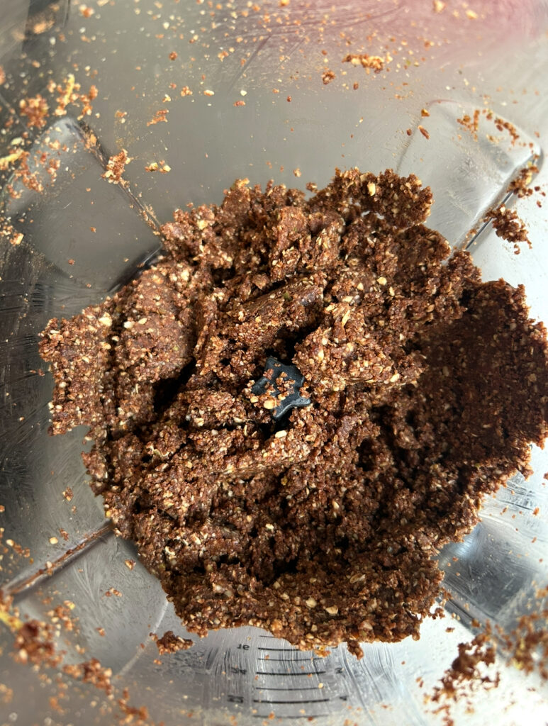 bliss ball ingredients in a food processor after they have been pureed