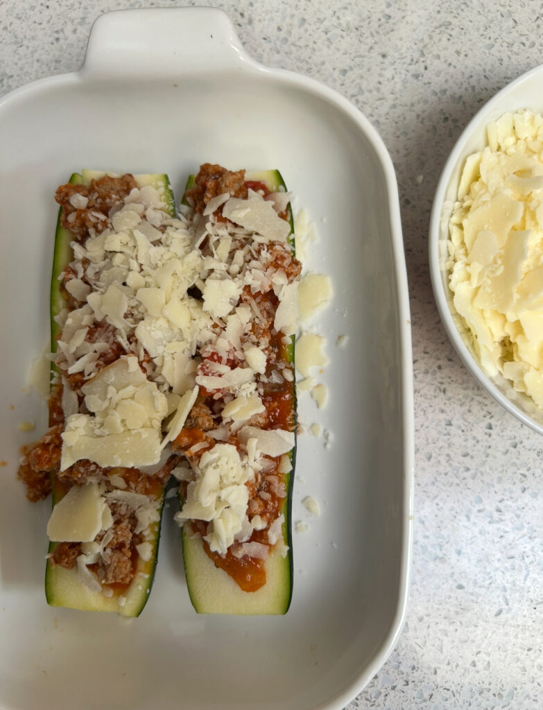 Zucchini boats stuffed with lean meat sauce and covered in cheese
